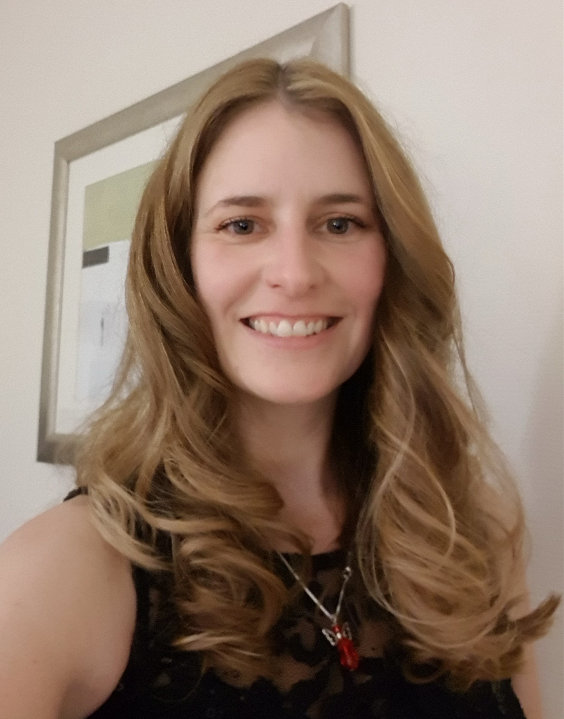 A headshot of a smiling woman 